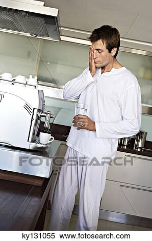 Man in kitchen preparing coffee, indoors View Large Photo Image Stock Photography - Man in kitchen preparing coffee, indoors. Fotosearch