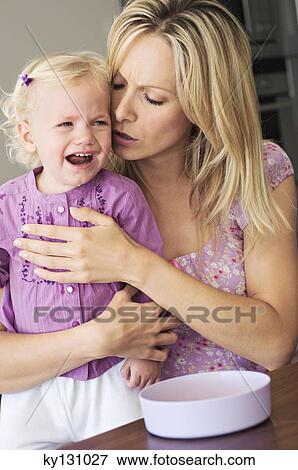 Mother and little girl crying, indoors View Large Photo Image Stock Photo - Mother and little girl crying, indoors. Fotosearch