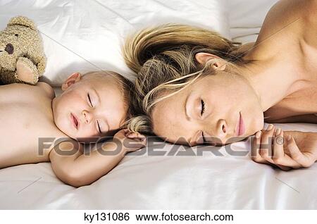Portrait of a baby and a mother sleeping, indoors View Large Photo Image Stock Photograph - Portrait of a baby and a mother sleeping, indoors. Fotosearch