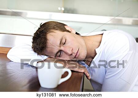 Portrait of a man sleeping on table in kitchen, indoors View Large Photo Image Stock Image - Portrait of a man sleeping on table in kitchen, indoors. Fotosearch