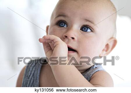 Portrait of a thoughful baby, indoors View Large Photo Image Stock Photograph - Portrait of a thoughful baby, indoors. Fotosearch