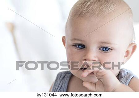Portrait of a thoughtful baby, indoors View Large Photo Image Picture - Portrait of a thoughtful baby, indoors. Fotosearch