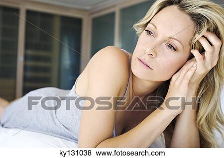 Stock Photo - Young thoughtful woman, indoors. Fotosearch