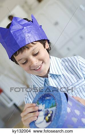 Christmas day, portrait of a little boy opening his present in a blue box, indoors View Large Photo Image Picture - Christmas day, portrait of a little boy opening his present in a blue box, indoors. Fotosearch
