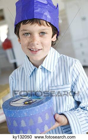 Christmas day, portrait of a little boy opening his present in a blue box, indoors View Large Photo Image Stock Image - Christmas day, portrait of a little boy opening his present in a blue box, indoors. Fotosearch