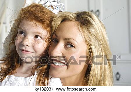 Christmas day, portrait of a mother and daughter smiling, looking at the camera, indoors View Large Photo Image Stock Photo - Christmas day, portrait of a mother and daughter smiling, looking at the camera, indoors. Fotosearch