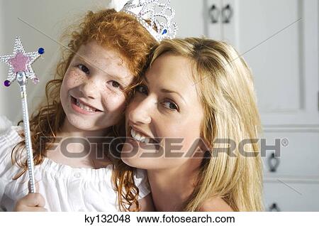 Christmas day, portrait of a mother and daughter smiling, looking at the camera, indoors View Large Photo Image Stock Photo - Christmas day, portrait of a mother and daughter smiling, looking at the camera, indoors. Fotosearch