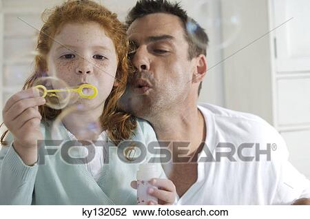 Father and daughter making soap bubbles, indoors View Large Photo Image Stock Image - Father and daughter making soap bubbles, indoors. Fotosearch