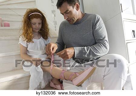 Father and daughter opening Christmas presents, girl holding a princess costume, indoors View Large Photo Image Stock Photograph - Father and daughter opening Christmas presents, girl holding a princess costume, indoors. Fotosearch