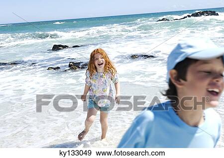Boy and little girl walking on the beach, outdoors View Large Photo Image Stock Photo - Boy and little girl walking on the beach, outdoors. Fotosearch