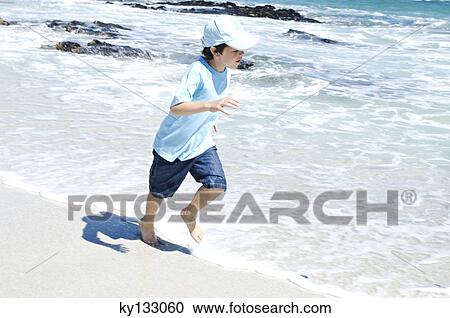 Boy running on the beach, outdoors View Large Photo Image Stock Image - Boy running on the beach, outdoors. Fotosearch