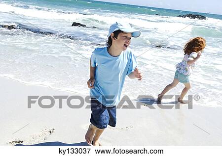 Brother and sister running on the beach, outdoors View Large Photo Image Stock Photo - Brother and sister running on the beach, outdoors. Fotosearch