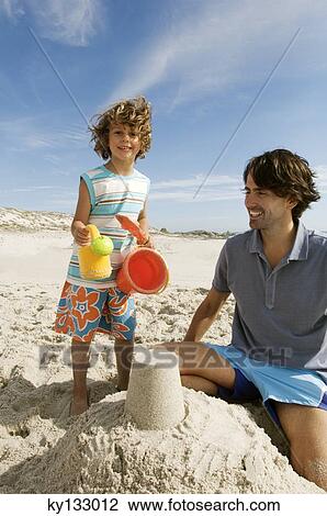 Father and son playing on the beach, outdoors View Large Photo Image Stock Image - Father and son playing on the beach, outdoors. Fotosearch