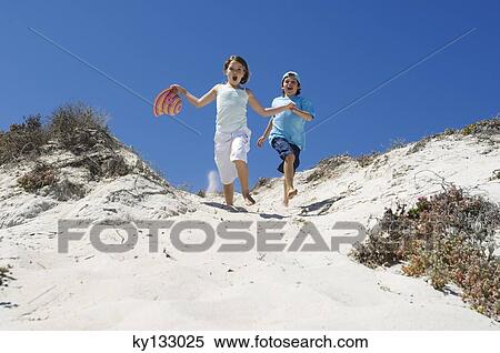 Little girl and little boy running on the beach, outdoors View Large Photo Image Stock Photography - Little girl and little boy running on the beach, outdoors. Fotosearch