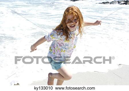 Little girl walking on the beach, outdoors View Large Photo Image Stock Image - Little girl walking on the beach, outdoors. Fotosearch