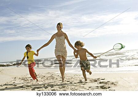 Mother and two children running on the beach, outdoors View Large Photo Image Stock Photograph - Mother and two children running on the beach, outdoors. Fotosearch