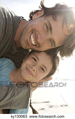 Portrait of father and daughter posing for the camera, outdoors View Large Photo Image Stock Image - Portrait of father and daughter posing for the camera, outdoors. Fotosearch
