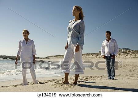 Stock Photo - Couple and senior woman on the beach. Fotosearch