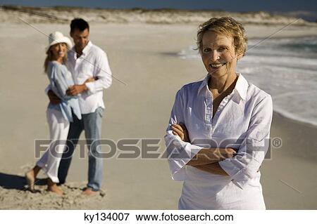 Couple embracing and senior woman on the beach View Large Photo Image Stock Photo - Couple embracing and senior woman on the beach. Fotosearch