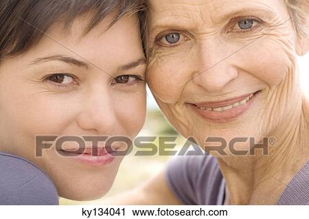 Senior woman and adult daughter smiling for the camera, outdoors View Large Photo Image Stock Image - Senior woman and adult daughter smiling for the camera, outdoors. Fotosearch