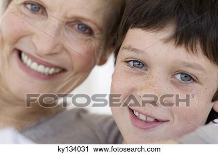 Senior woman and little boy smiling for the camera, indoors View Large Photo Image Stock Image - Senior woman and little boy smiling for the camera, indoors. Fotosearch