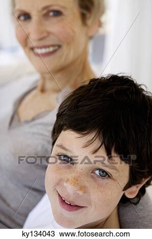 Senior woman and little boy smiling for the camera, indoors View Large Photo Image Stock Image - Senior woman and little boy smiling for the camera, indoors. Fotosearch