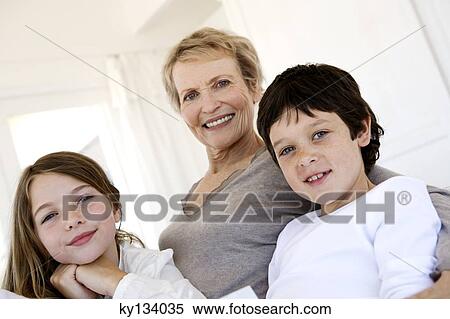 Senior woman and three children looking at the camera, indoors View Large Photo Image Stock Photography - Senior woman and three children looking at the camera, indoors. Fotosearch