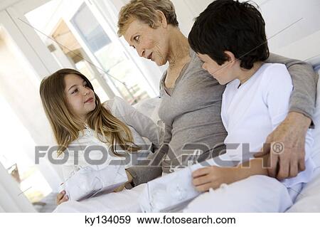Senior woman and two children holding gifts, indoors View Large Photo Image Stock Photo - Senior woman and two children holding gifts, indoors. Fotosearch