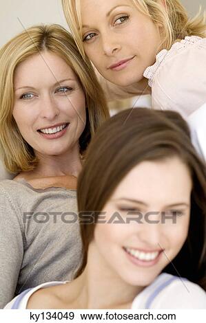 Stock Photo - Three smiling women, indoors. Fotosearch
