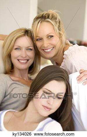 Three smiling women, indoors View Large Photo Image Stock Photograph - Three smiling women, indoors. Fotosearch
