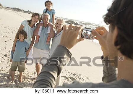 Stock Image - Family on the beach. Fotosearch