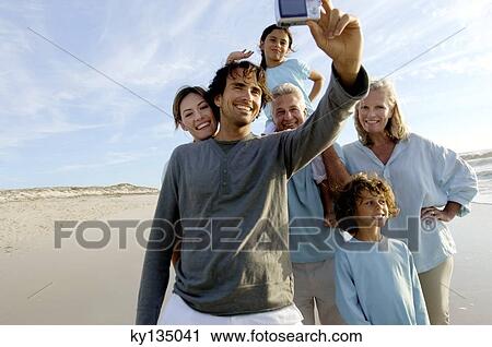 Stock Image - Family on the beach. Fotosearch