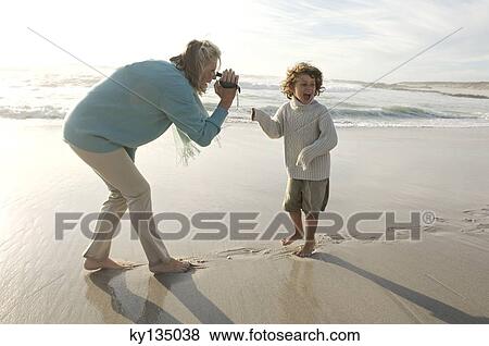Grand mother and grand son on the beach View Large Photo Image Stock Photo - Grand mother and grand son on the beach. Fotosearch