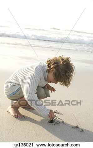Little boy on the beach View Large Photo Image Stock Image - Little boy on the beach. Fotosearch