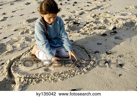 Little girl playing on the beach View Large Photo Image Stock Image - Little girl playing on the beach. Fotosearch