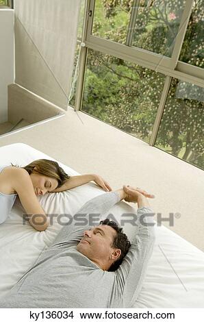 Couple in bed, indoors View Large Photo Image Picture - Couple in bed, indoors. Fotosearch