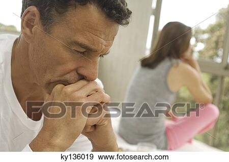 Couple in bedroom, woman in background, indoors View Large Photo Image Stock Photo - Couple in bedroom, woman in background, indoors. Fotosearch