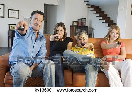 Family watching television, indoors View Large Photo Image Stock Image - Family watching television, indoors. Fotosearch