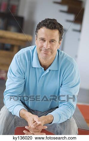 Man posing for the camera, indoors View Large Photo Image Stock Image - Man posing for the camera, indoors. Fotosearch