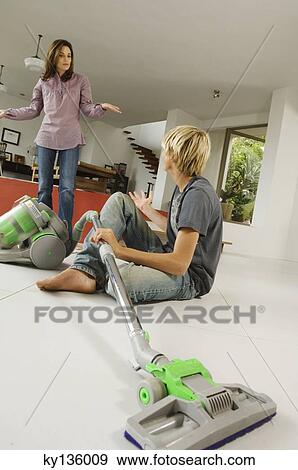 Mother and son in living room, vacuum cleaner, indoors View Large Photo Image Stock Photo - Mother and son in living room, vacuum cleaner, indoors. Fotosearch