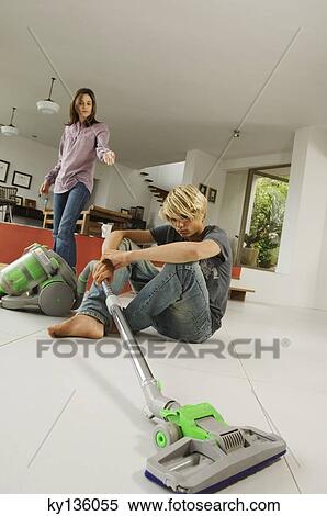 Mother and son in living room, vacuum cleaner, indoors View Large Photo Image Stock Photography - Mother and son in living room, vacuum cleaner, indoors. Fotosearch