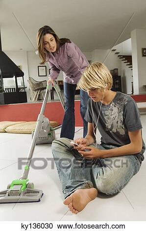 Mother vacuuming and speaking to his son, sitting on floor, indoors View Large Photo Image Stock Image - Mother vacuuming and speaking to his son, sitting on floor, indoors. Fotosearch