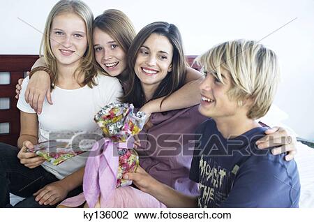Portrait of a mother and her three children teenagers, indoors View Large Photo Image Stock Image - Portrait of a mother and her three children teenagers, indoors. Fotosearch
