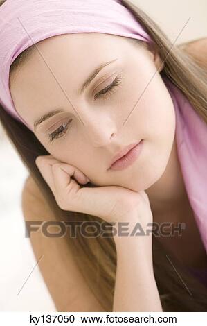 Portrait of a thoughtful young woman, indoors View Large Photo Image Stock Image - Portrait of a thoughtful young woman, indoors. Fotosearch