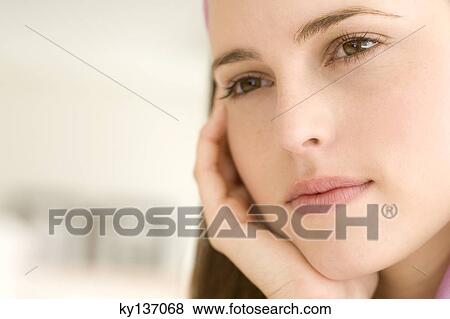 Portrait of a thoughtful young woman, indoors View Large Photo Image Stock Photo - Portrait of a thoughtful young woman, indoors. Fotosearch