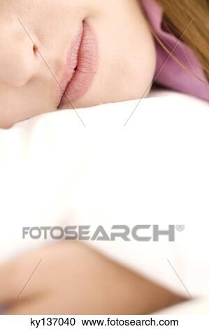 Portrait of a young woman lying, close-up of mouth, indoors View Large Photo Image Stock Image - Portrait of a young woman lying, close-up of mouth, indoors. Fotosearch