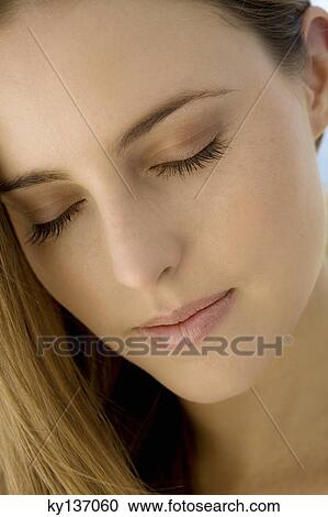 Portrait of a young woman, shut eyes, indoors View Large Photo Image Stock Image - Portrait of a young woman, shut eyes, indoors. Fotosearch