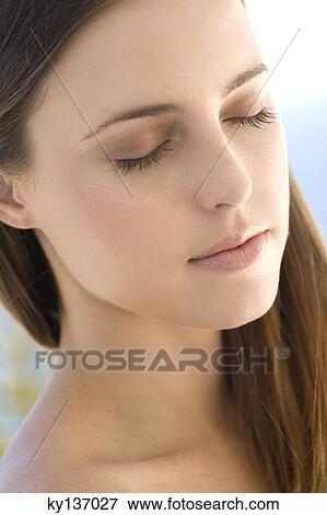 Portrait of a young woman, shut eyes, indoors View Large Photo Image Stock Photo - Portrait of a young woman, shut eyes, indoors. Fotosearch