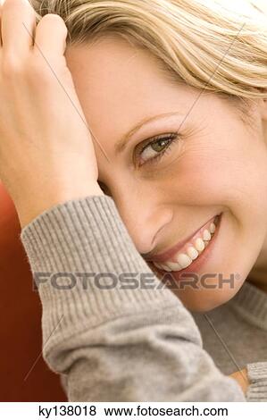 Stock Photo - Portrait of a woman smiling for the camera. Fotosearch