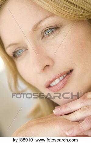 Stock Image - Portrait of a young thinking woman. Fotosearch